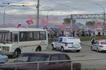 Колонну военных автомобилей встретили в Новосибирске с флагами и дымовыми факелами