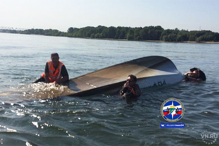Рыбак без жилета залез на перевернутую лодку, рядом плавали двое