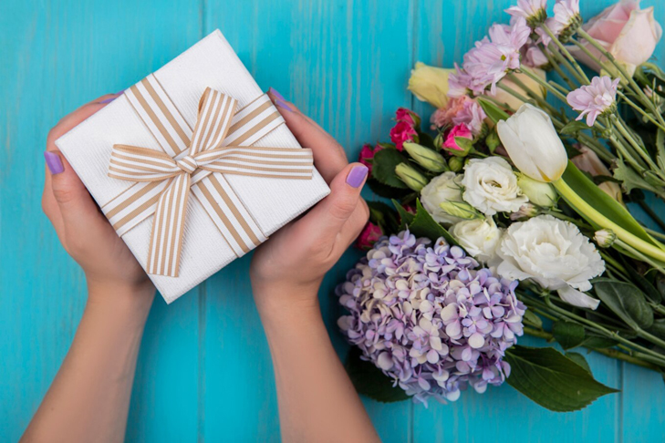 Фото VN.ru top_view_female_hands_holding_gift_box_with_wonderful_fresh_flowers.jpg